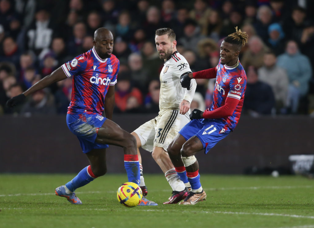 Wilfried Zaha and Jean-Philippe Mateta in action for Crystal Palace during a Premier League clash against Manchester United
