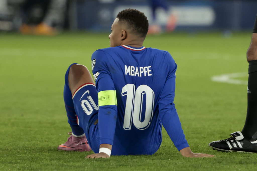 Injured, Kylian Mbappe of France will leave the pitch.