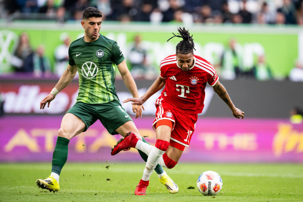 Konstantinos Koulierakis challenges Michael Olise: VfL Wolfsburg v FC Bayern München - Bundesliga